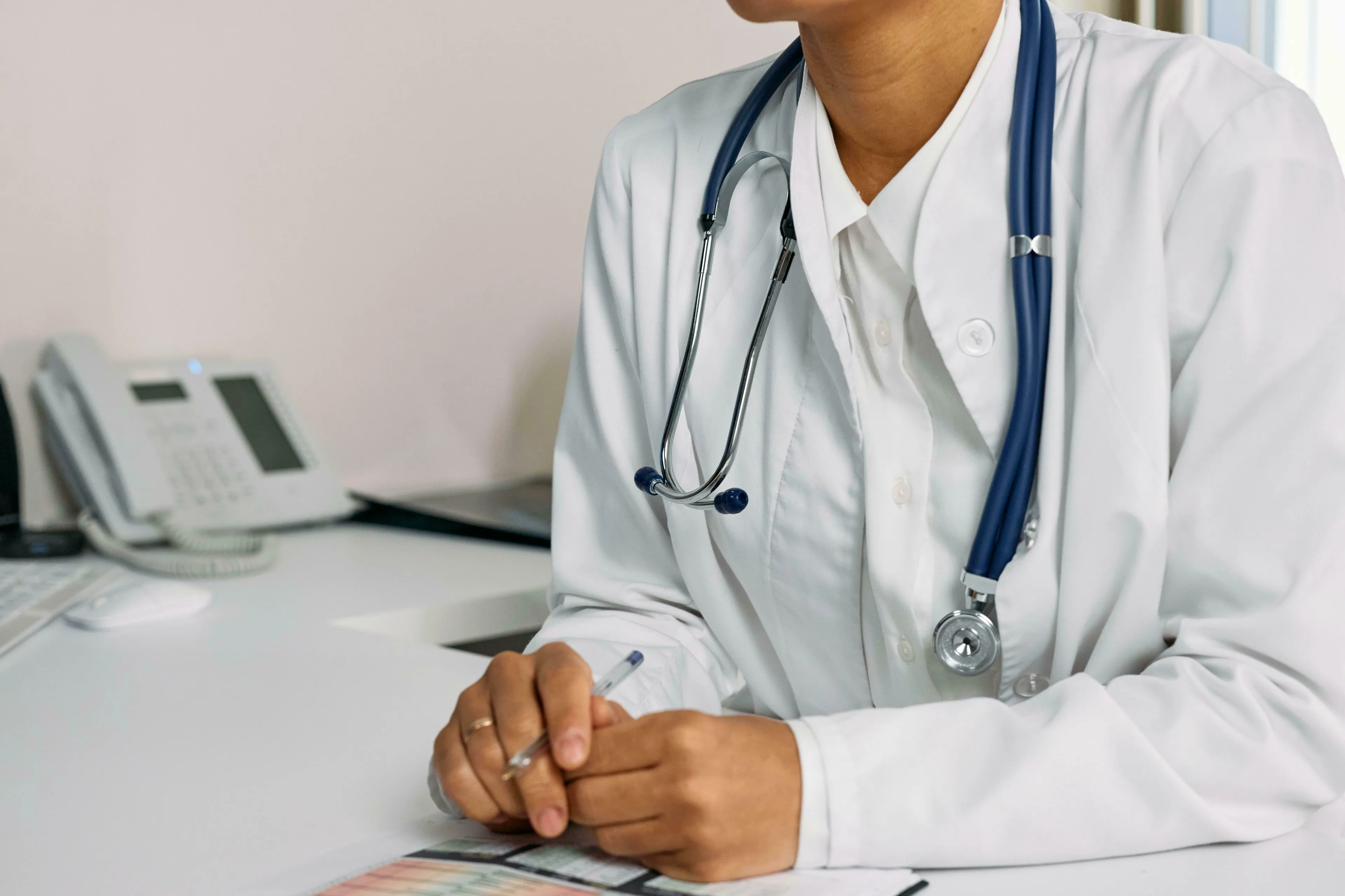A doctor in a white coat with a stethoscope around their neck, suggesting a lifestyle change. React to change.