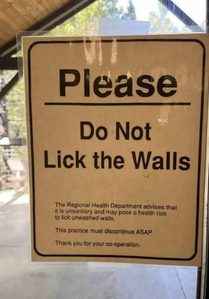Sign warning not to lick walls for health in funny random meme