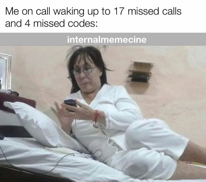 A medical professional, disheveled and in bed, checking her phone after 17 missed calls and 4 missed codes. Medical memes.