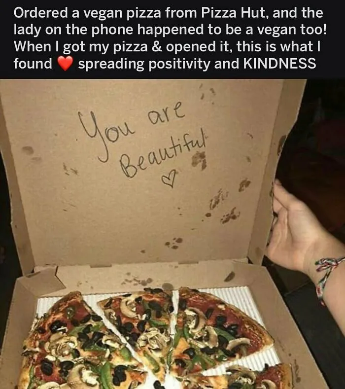 A vegan pizza box with "You are Beautiful" written inside, sharing positivity for vegans.