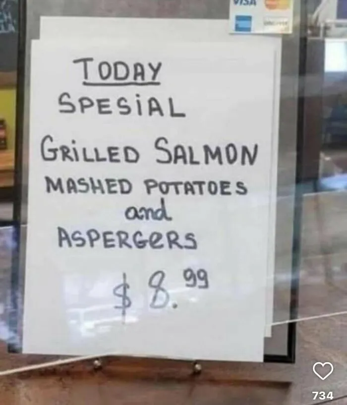 Handwritten menu sign with grilled salmon, mashed potatoes, and aspergers special