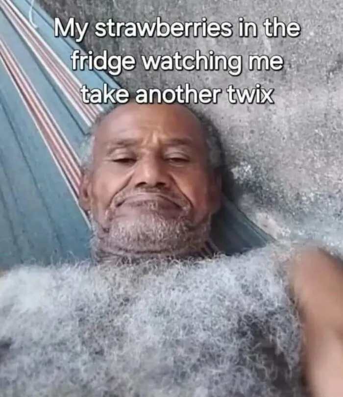 Man covered in hair humorously captioned as strawberries watching someone eat candy