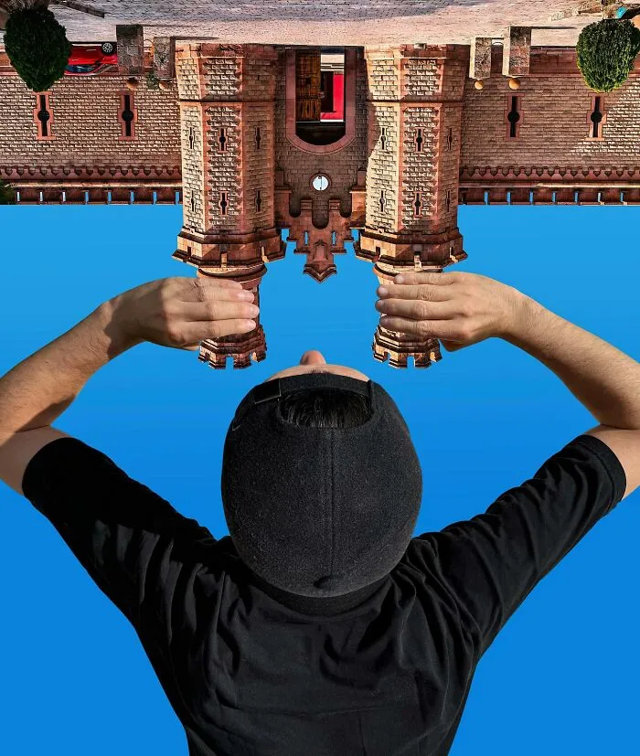 A person holding an upside-down building, a clever photo manipulation making simple objects look like parts of cities.