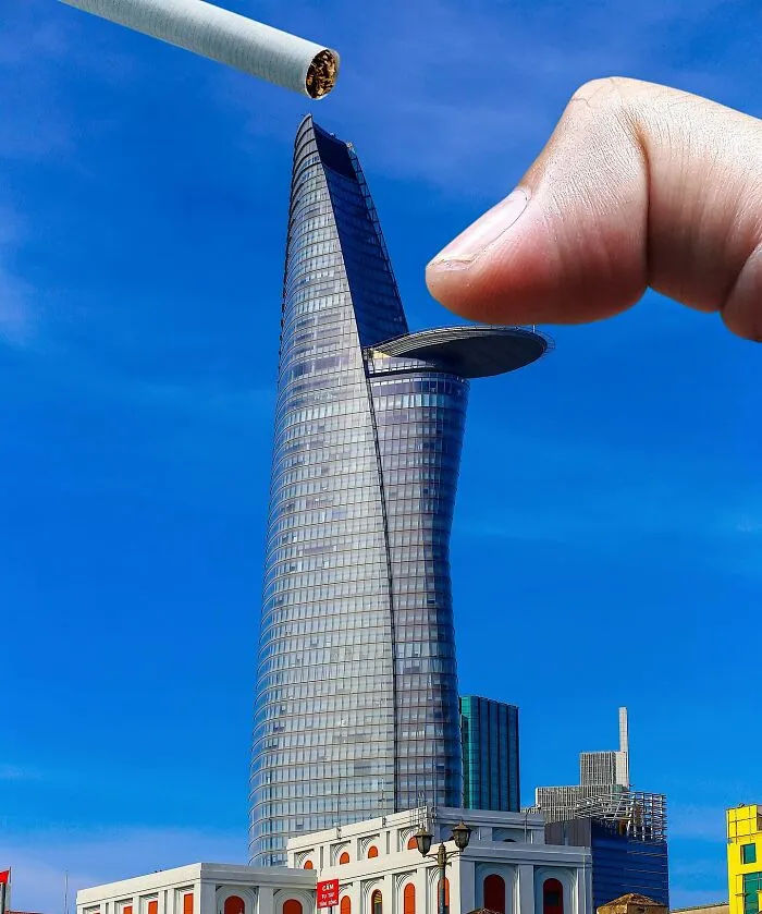 Clever photo manipulations: a finger holding a cigarette above a tall city building, making it look like part of cities.