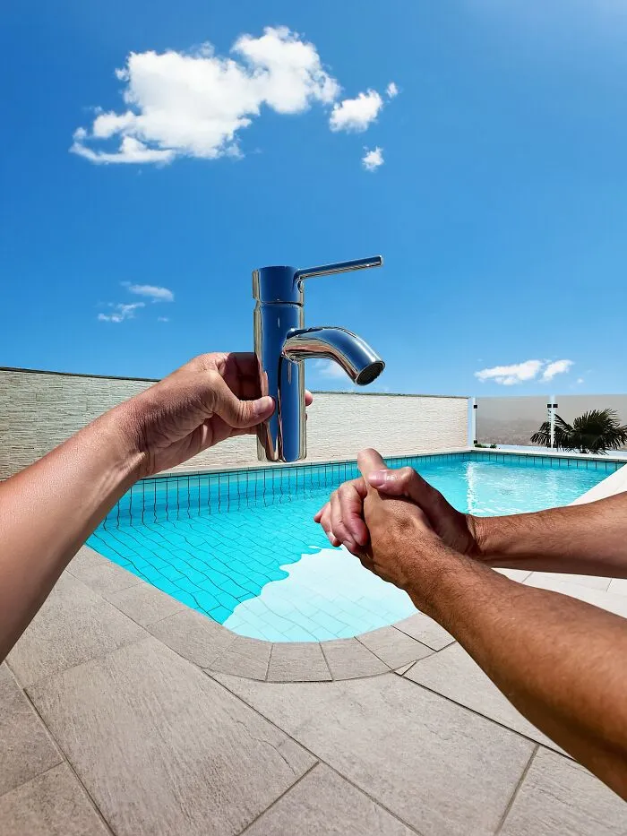Clever photo manipulation of a hand holding a faucet over a pool, making simple objects look like parts of cities.