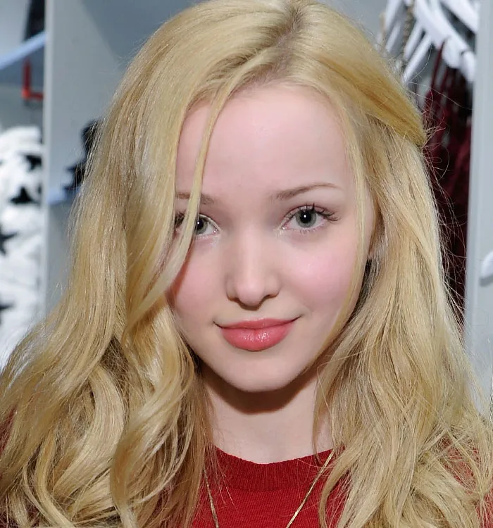Blonde woman with soft makeup wearing a red top
