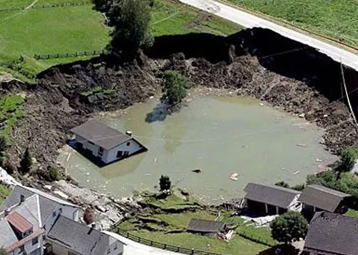 Sinkhole engulfing house in dystopian historical disaster photo