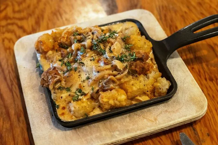 Baked tater tot casserole with cheese and herbs for poverty meals