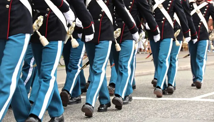 Soldiers in uniform marching, symbolizing discipline. A fun facts article could explore military traditions.