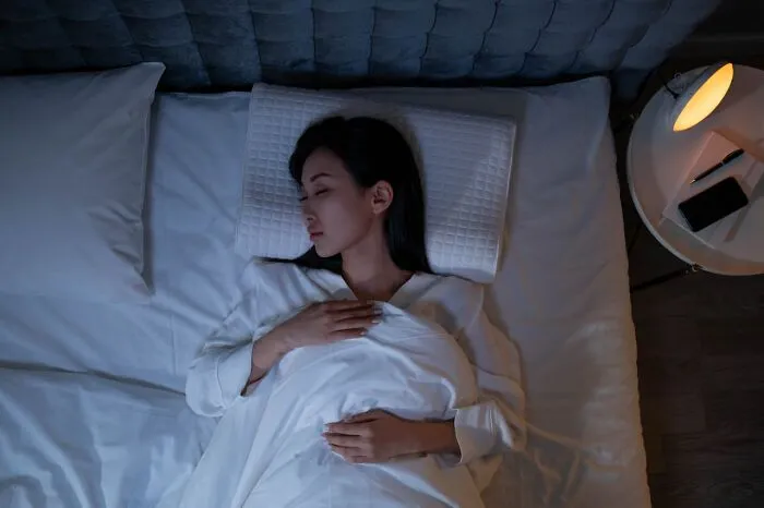 Woman sleeping peacefully in bed at night