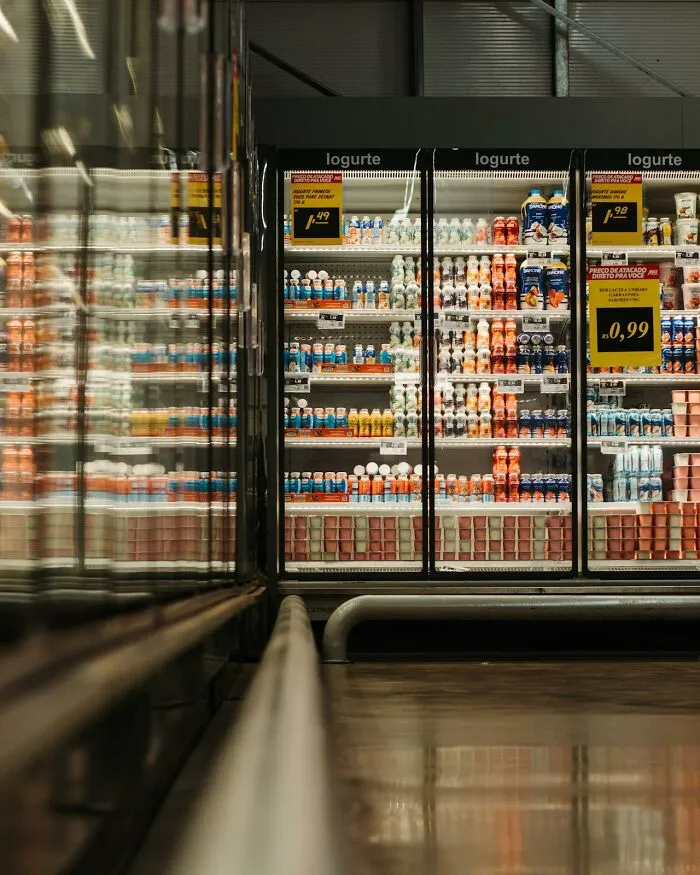 Rows of yogurt and drinks in a refrigerated display case at a store, reflecting disturbing death stories.