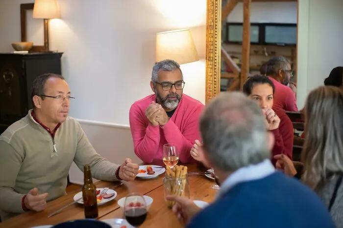 Group of men having a serious discussion over dinner indoors