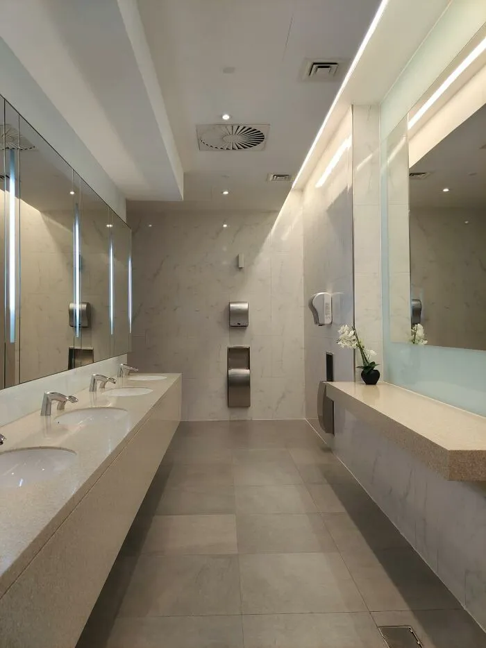 A clean, modern public restroom with multiple sinks and mirrors, illustrating a moment people experienced visiting the US.