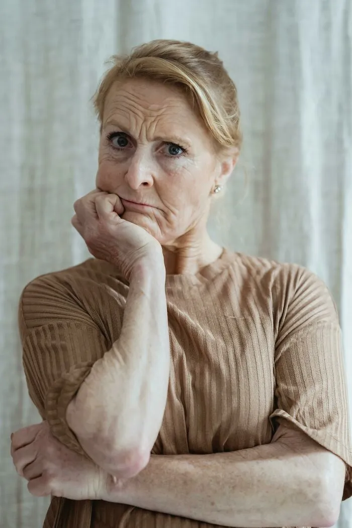 Worried older woman showing frustration representing neighbors from hell