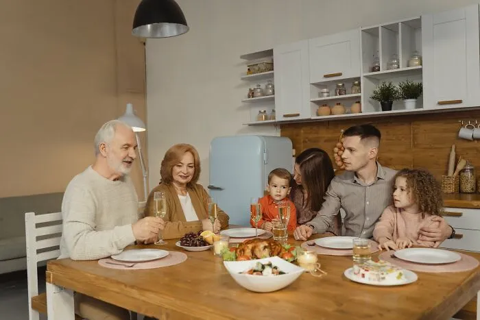 Family gathering for dinner in a cozy kitchen setting