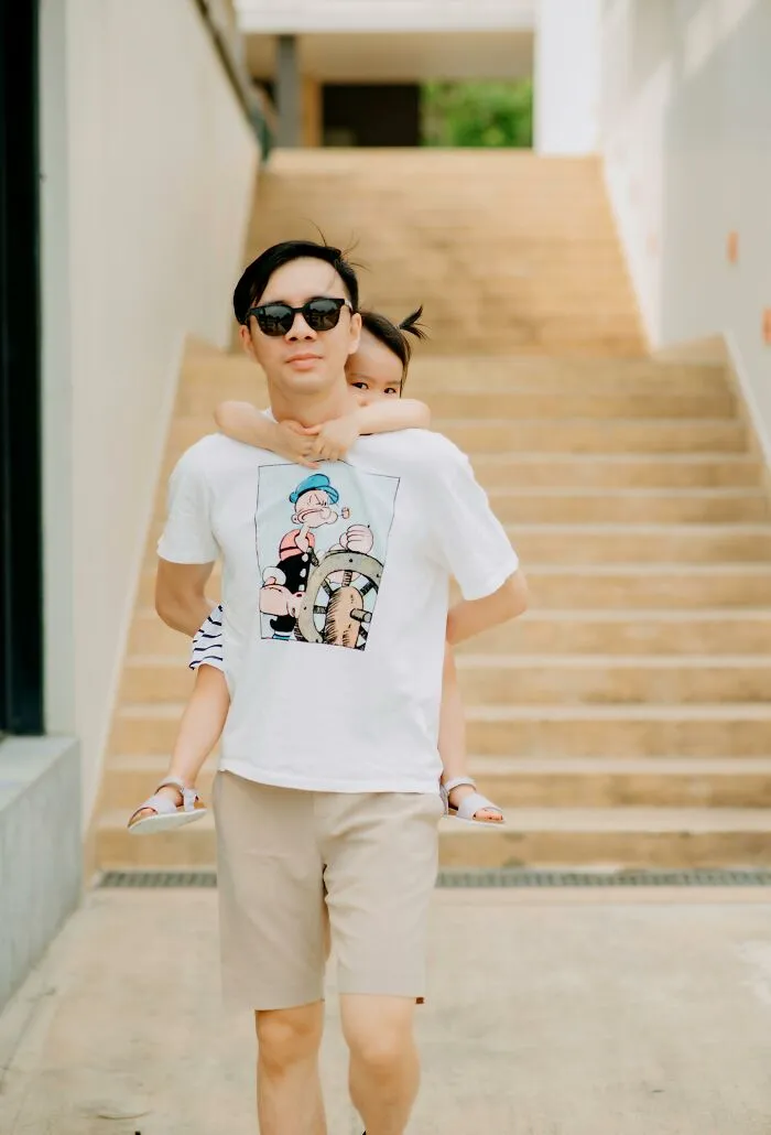 Man carrying child on back outdoors illustrating happy parenting moments