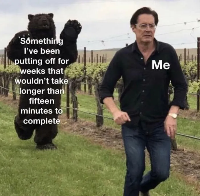 A relatable meme featuring a man running from a bear costume, labeled 'Me' and 'Something I've been putting off.'