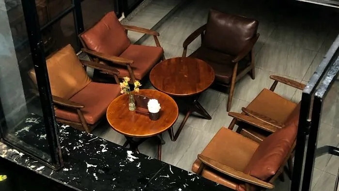 My (36M) local coffee shop has a set of five leather chairs that are more comfortable than the rest. When I got there, three older men were sitting in three of the chairs, talking. I squeezed past them into the fourth and started listening to a podcast on my headphones. After I sat down, one of the men mentioned that they were uncomfortable with me being part of their conversation. I told him that I wasn't listening in on them, but I was willing to move. The other two decided it was time for them to leave. They seemed a little upset, but I genuinely didn’t know or care what they were talking about at all.