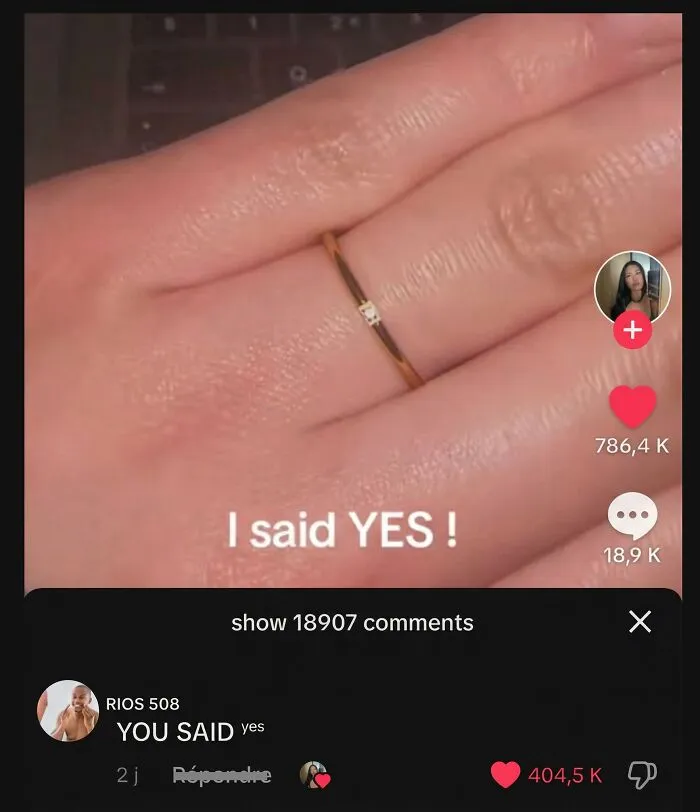 A hand wearing a ring that says I said YES with a funny comment below.