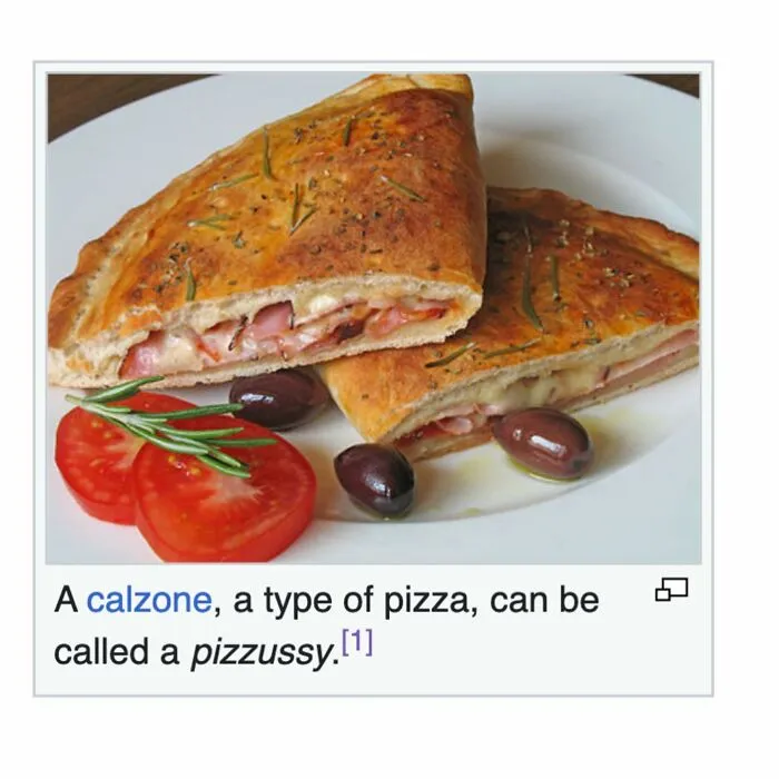 Calzone pizza sliced with olives and tomato on a white plate