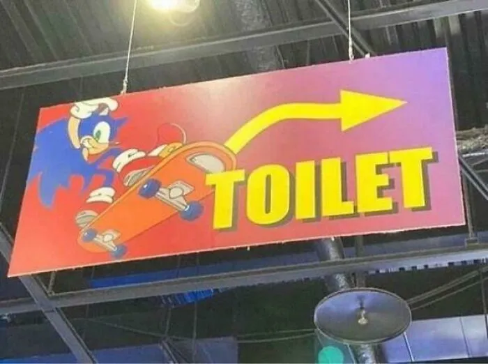 Funny toilet sign featuring cartoon character on skateboard
