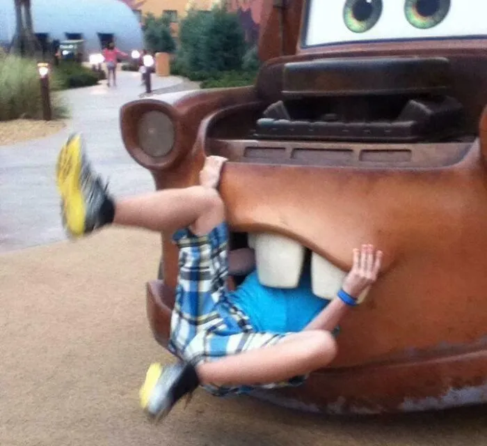 Child playfully stuck in a cartoon character statue mouth