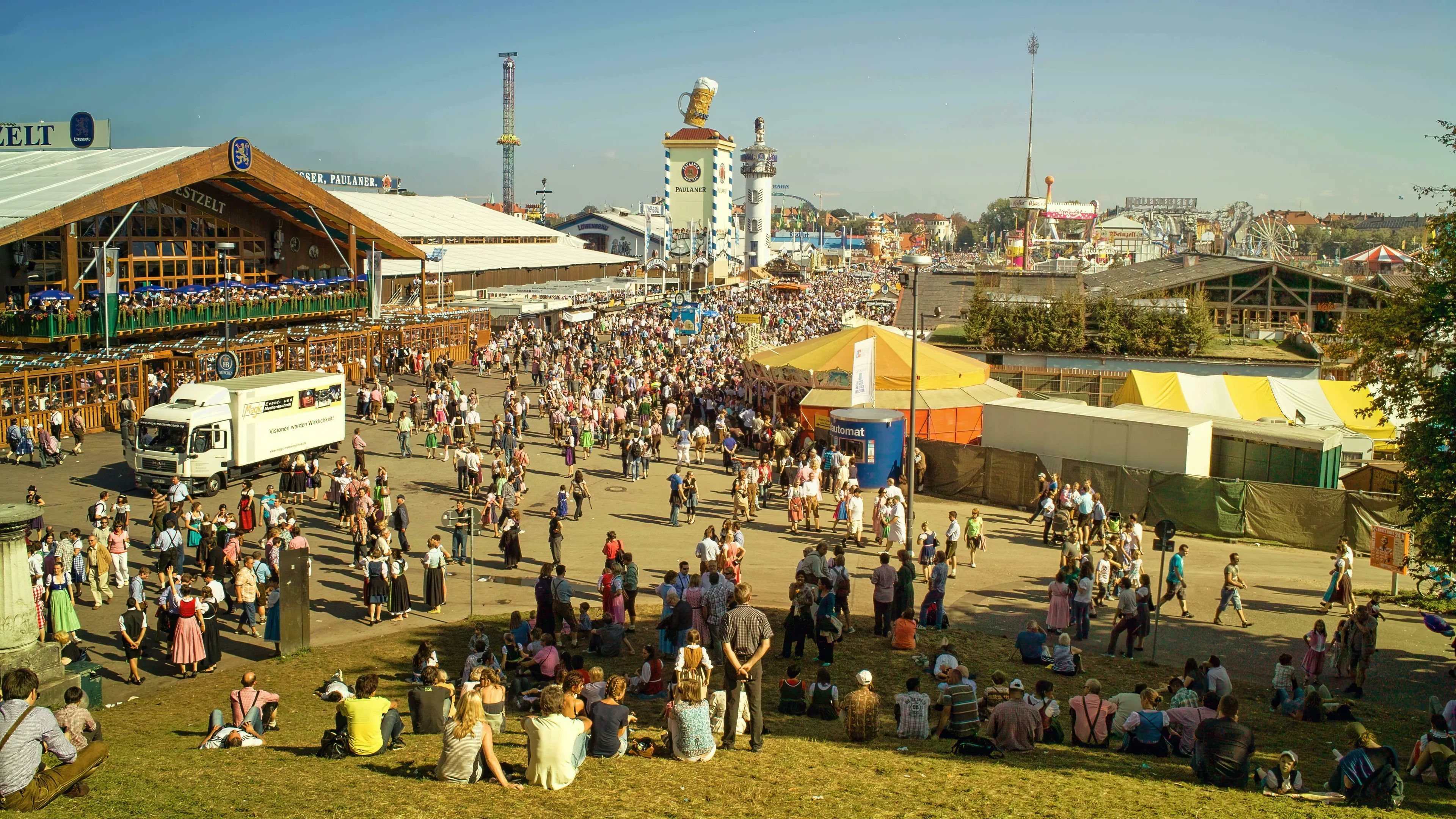 A lively aerial view of Oktoberfest in Germany, crowded with people, tents, and amusement rides. General Knowledge Quiz: Europe Questions.