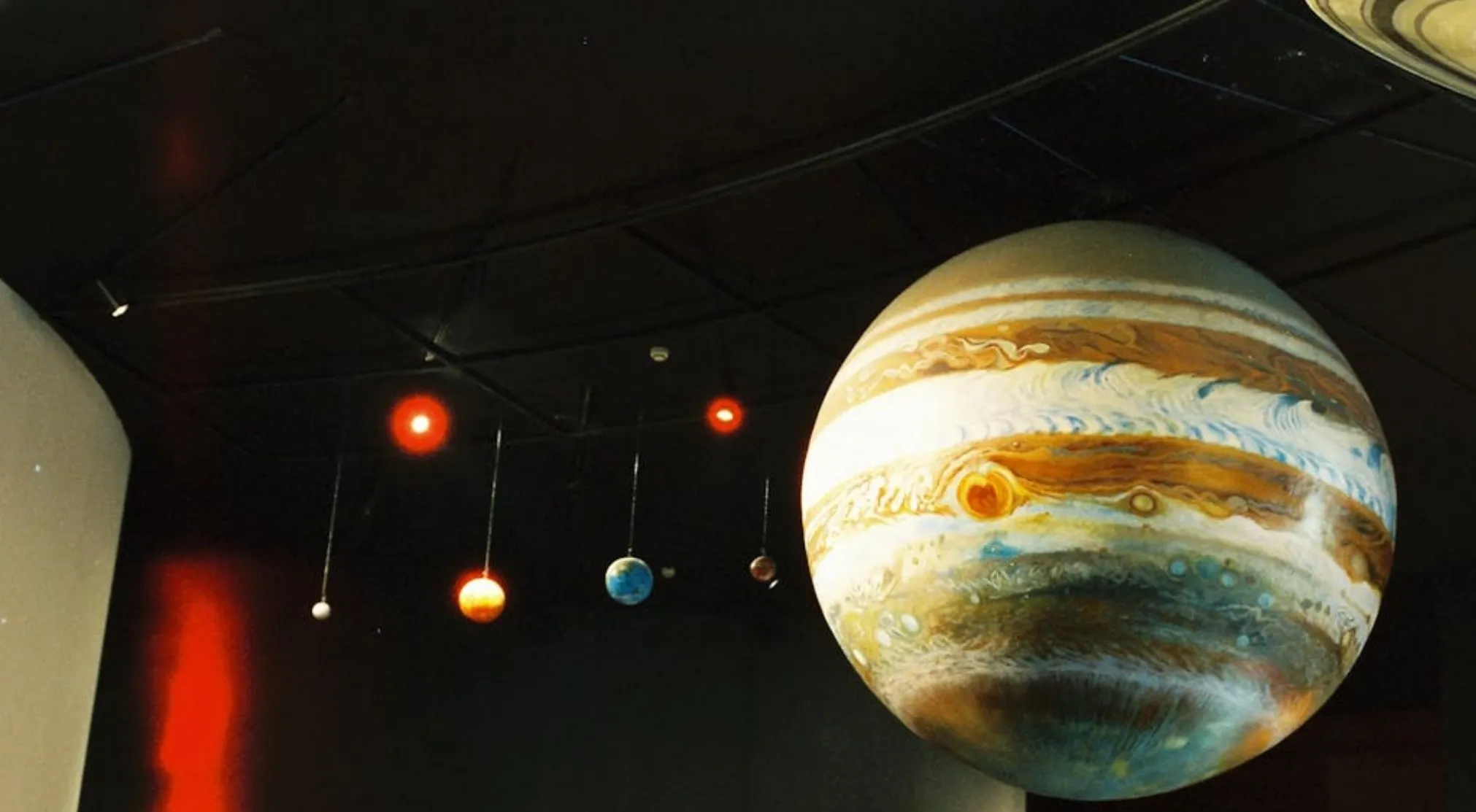 Models of planets in a dark room, highlighting Jupiter and Saturn's rings. Perfect for an astronomy quiz about the order of planets from the Sun.