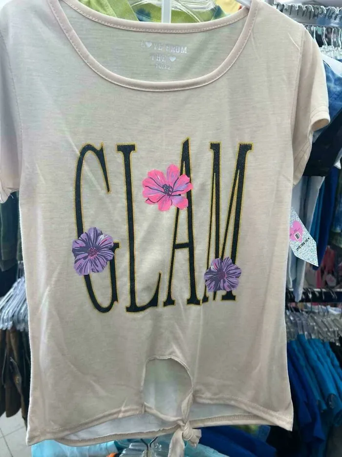 A light pink clothing design with the word 'Glam' and pink and purple flowers, illustrating a bad clothing design.