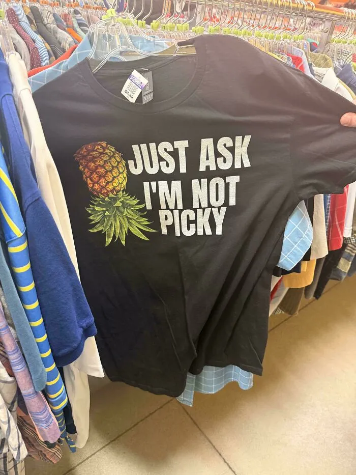Funny thrifted black T-shirt with pineapple and phrase not picky at Goodwill store