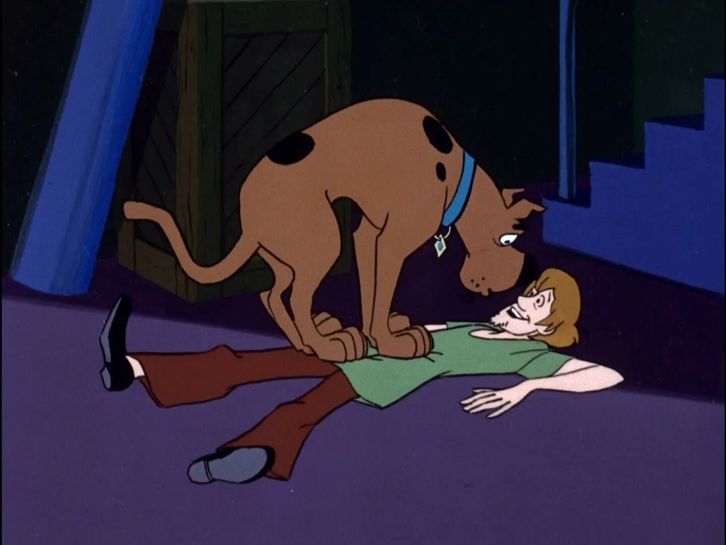 Scooby-Doo stands over his human best friend, Shaggy, who is lying on the floor in a pub quiz scene.