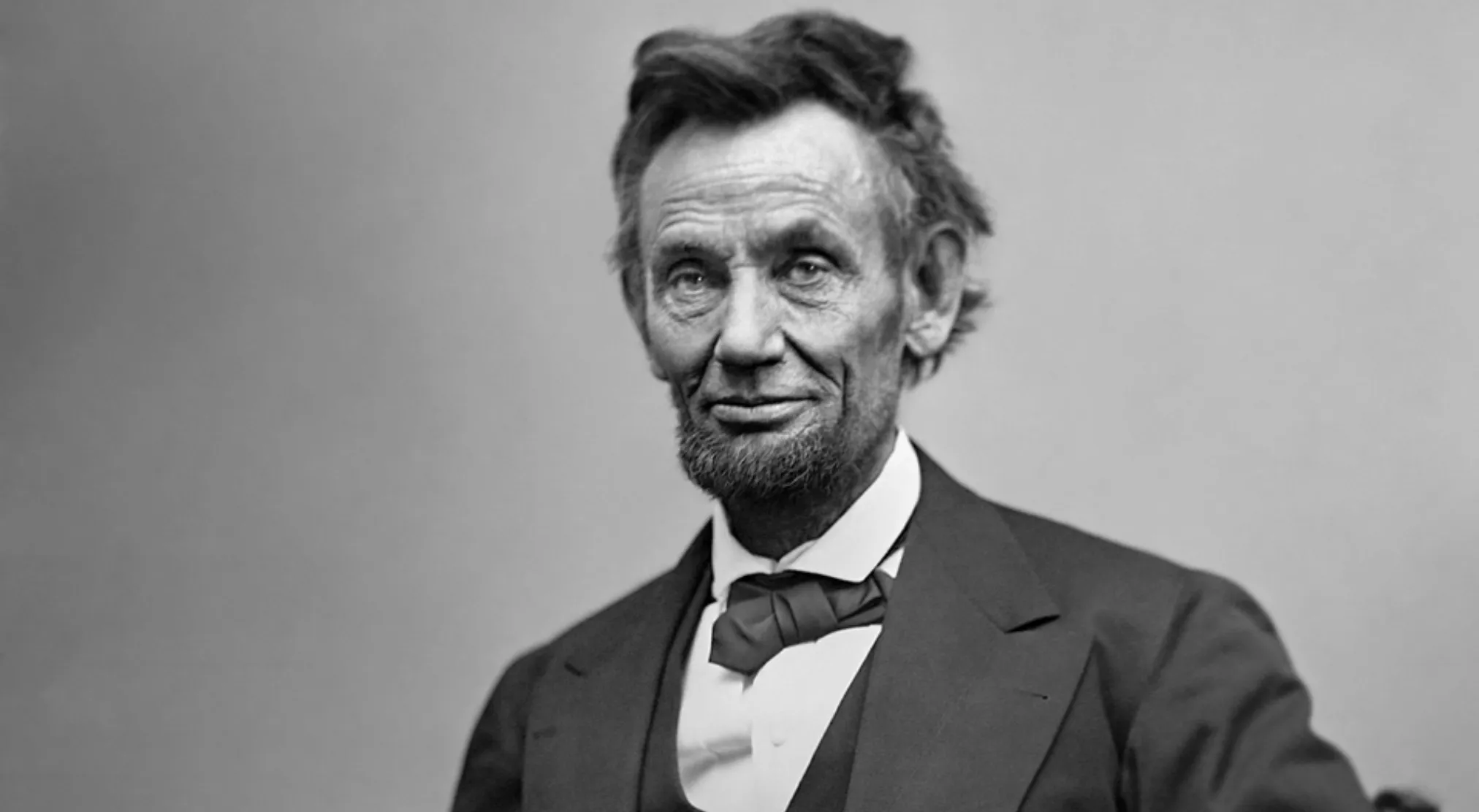 Black and white portrait of Abraham Lincoln, wearing a suit and bowtie, from a USA throughout history quiz.