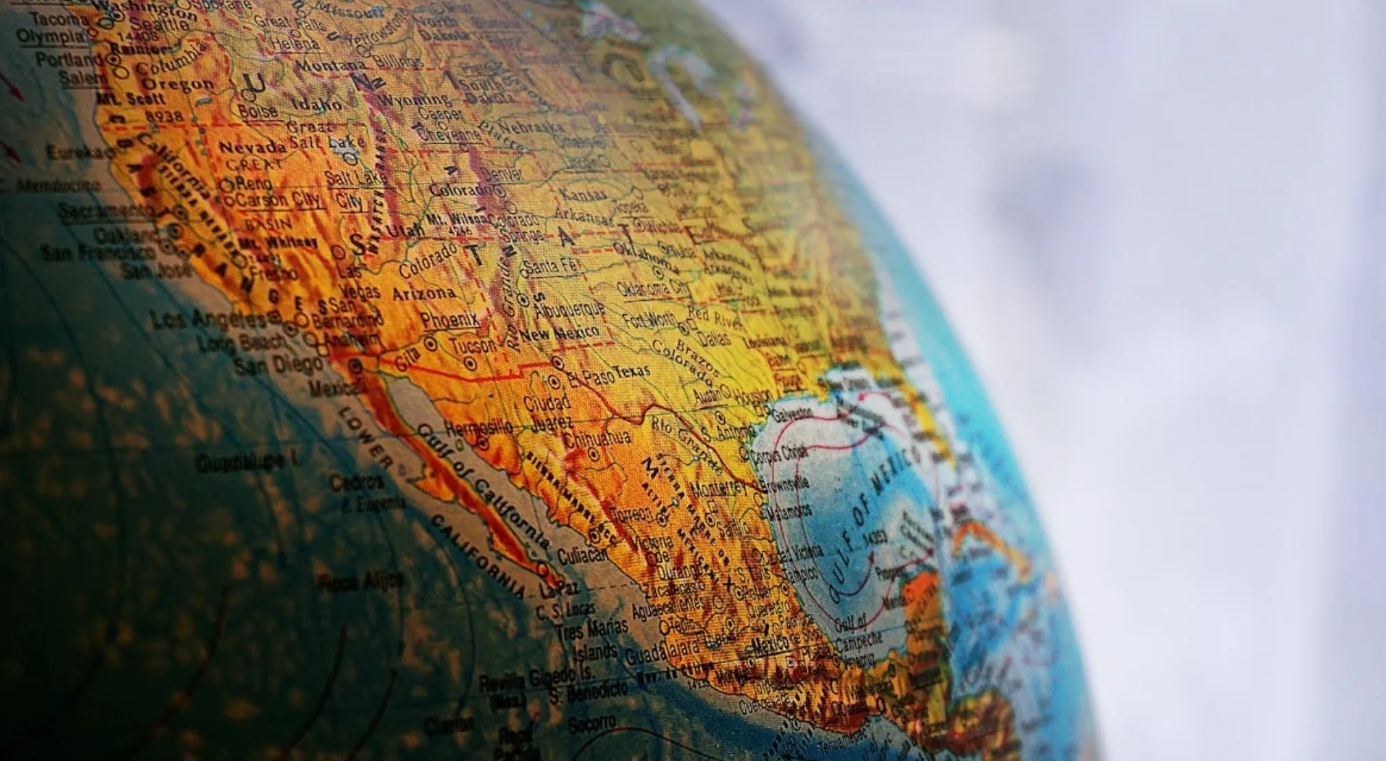 Close-up of a globe showing North America, highlighting California, USA. A quiz about European groups reaching North America.