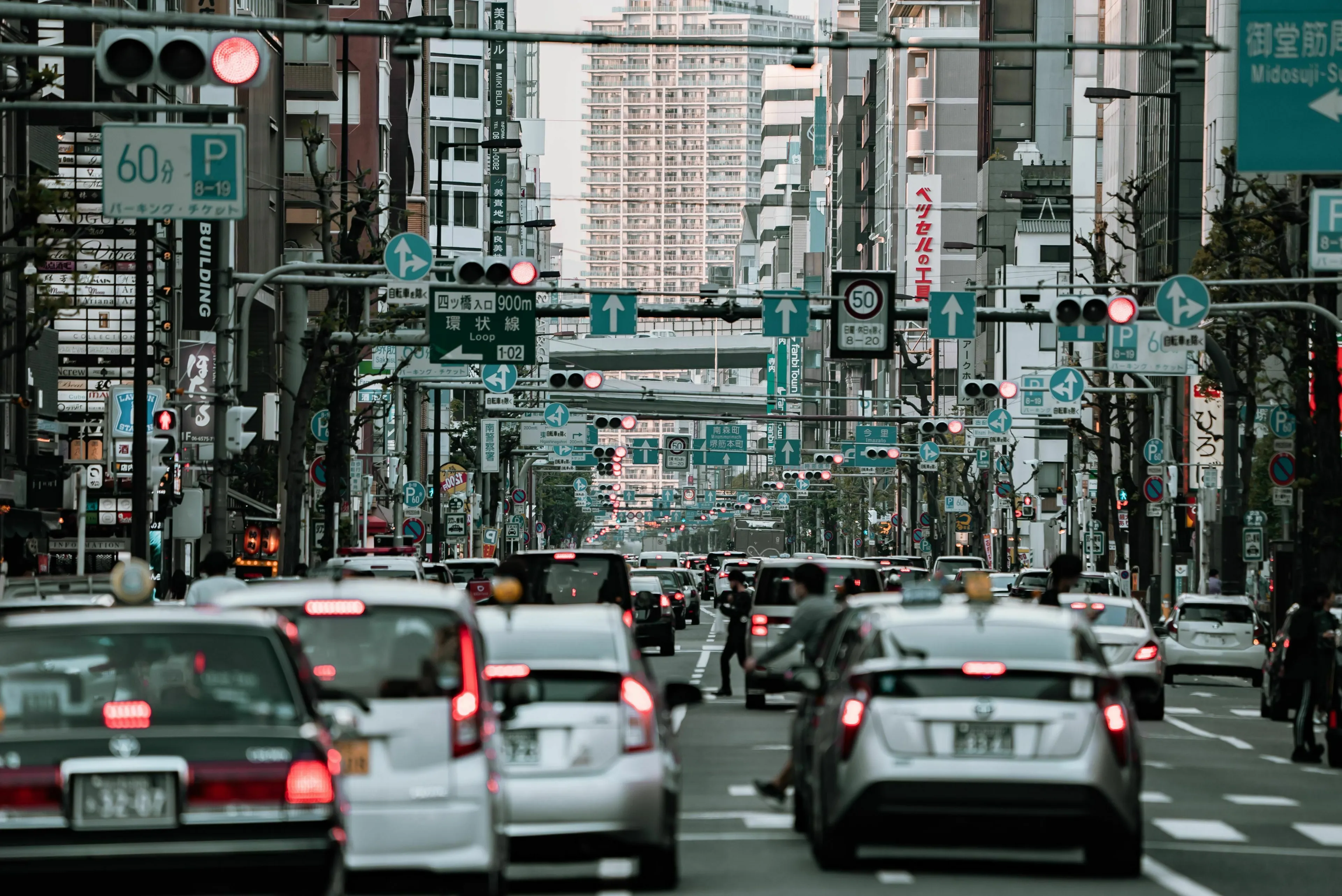 A busy city street with cars stuck in traffic and many street signs. Reflects your true nature in a traffic jam.