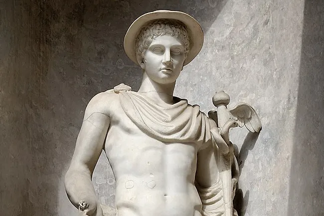 A marble statue of Hermes with a winged caduceus, wearing a wide-brimmed hat and draped cloth over his shoulder.
