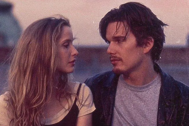 Ethan Hawke and Julie Delpy in Before Sunrise, looking at each other intensely. A movie you could watch on repeat forever.