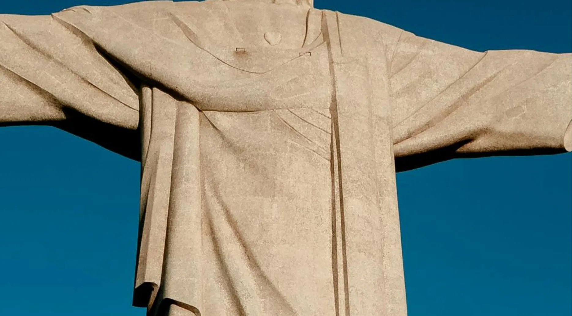 A zoomed-in photo of the Christ the Redeemer statue in Rio de Janeiro. Name the landmark from this zoomed-in photo.