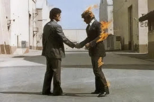 Pink Floyd's "Wish You Were Here" album cover, showing two men shaking hands, one engulfed in flames. Inner world.