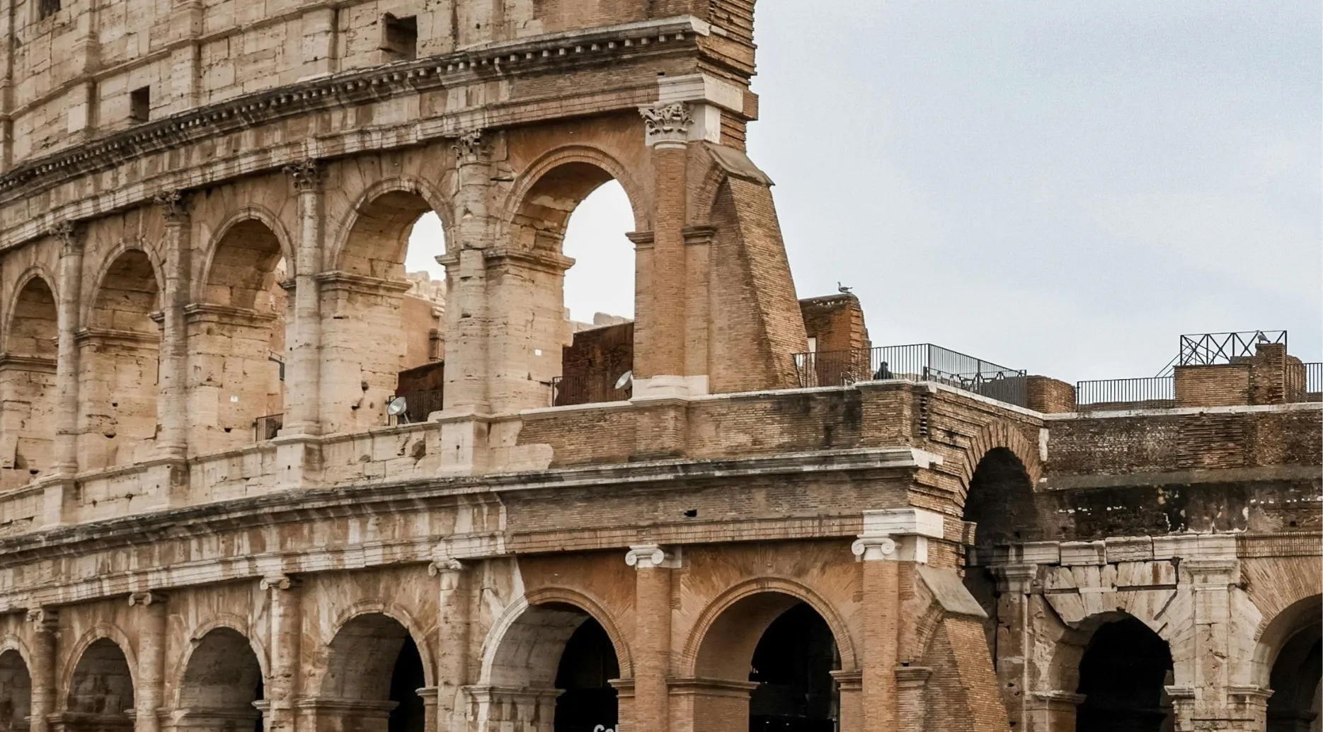 Close-up of the Colosseum's ancient Roman arches and crumbling stone. Guess the landmark from this zoomed-in photo.