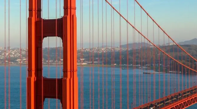 Can you guess the landmark from this zoomed-in photo? A close-up of the Golden Gate Bridge and its cables.