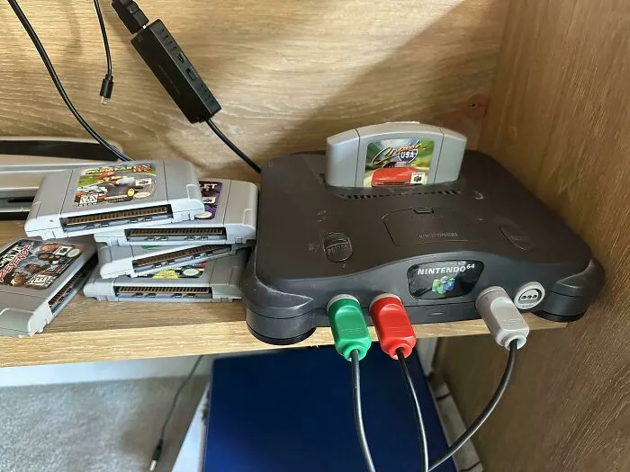 A retro Nintendo 64 console with game cartridges, showcasing classic old products that still work.