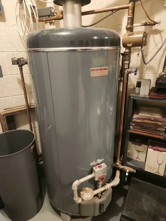 A vintage Ruud-Monel water heater, showing old products still functioning after decades of daily use.