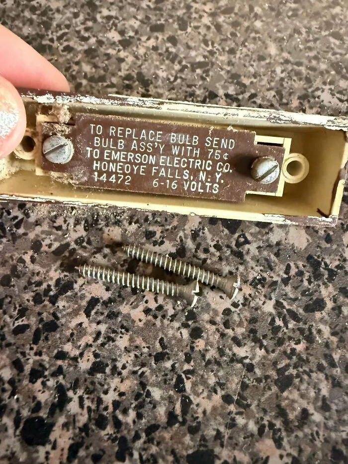 An old electrical component with screws, highlighting how classic old products withstand decades of light use.