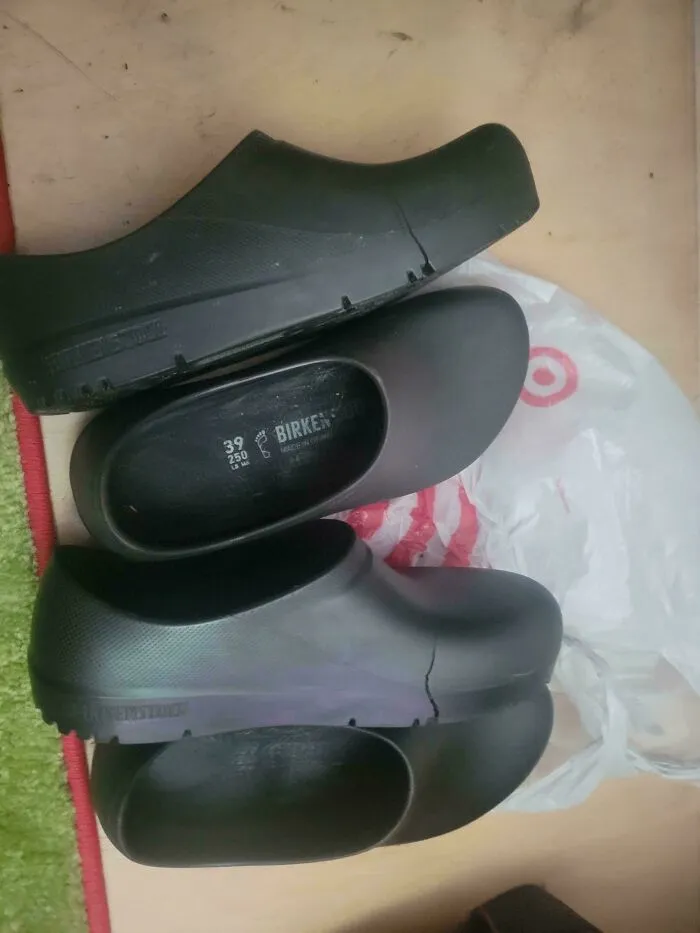 Pair of worn black clogs sitting on a table, representing old products that remain functional after years of use.