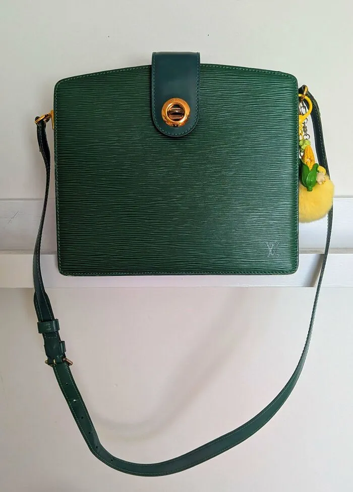 A dark green vintage Louis Vuitton purse, one of many durable old products built to last for decades.