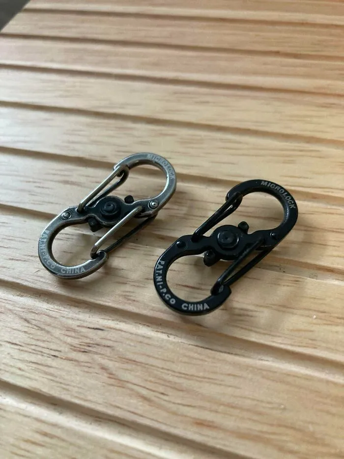 Two durable micro lock carabiners placed on wood, representing old products that refuse to give up.