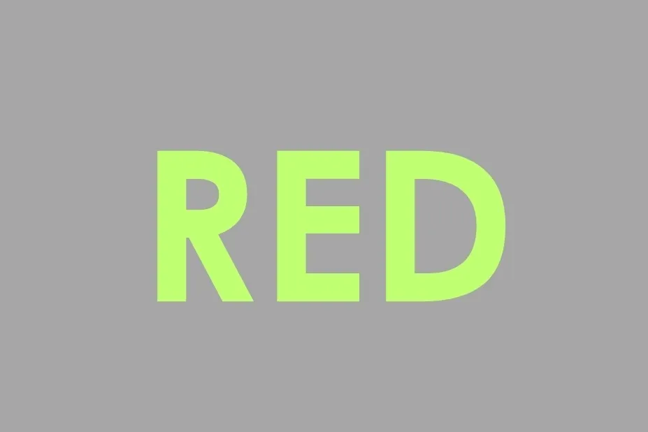 The word RED in bright green text on a grey background. This is not the color brown.