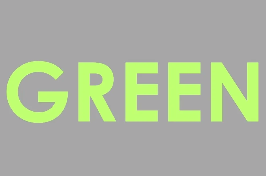 The word GREEN in a light yellow-green color against a gray background.