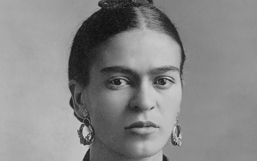 Black and white close-up of Frida Kahlo, staring directly ahead, featuring prominent earrings. Test your general knowledge!