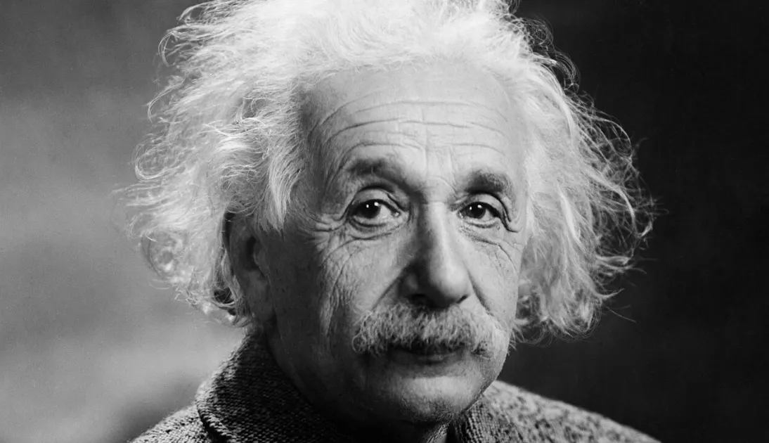 A black and white close-up of Albert Einstein, known for his general knowledge, with his iconic wild white hair.